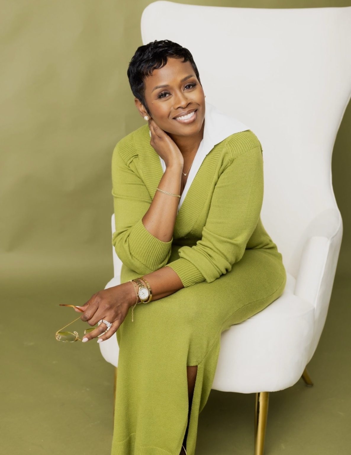 Autumn R. Russell smiling in an olive green look