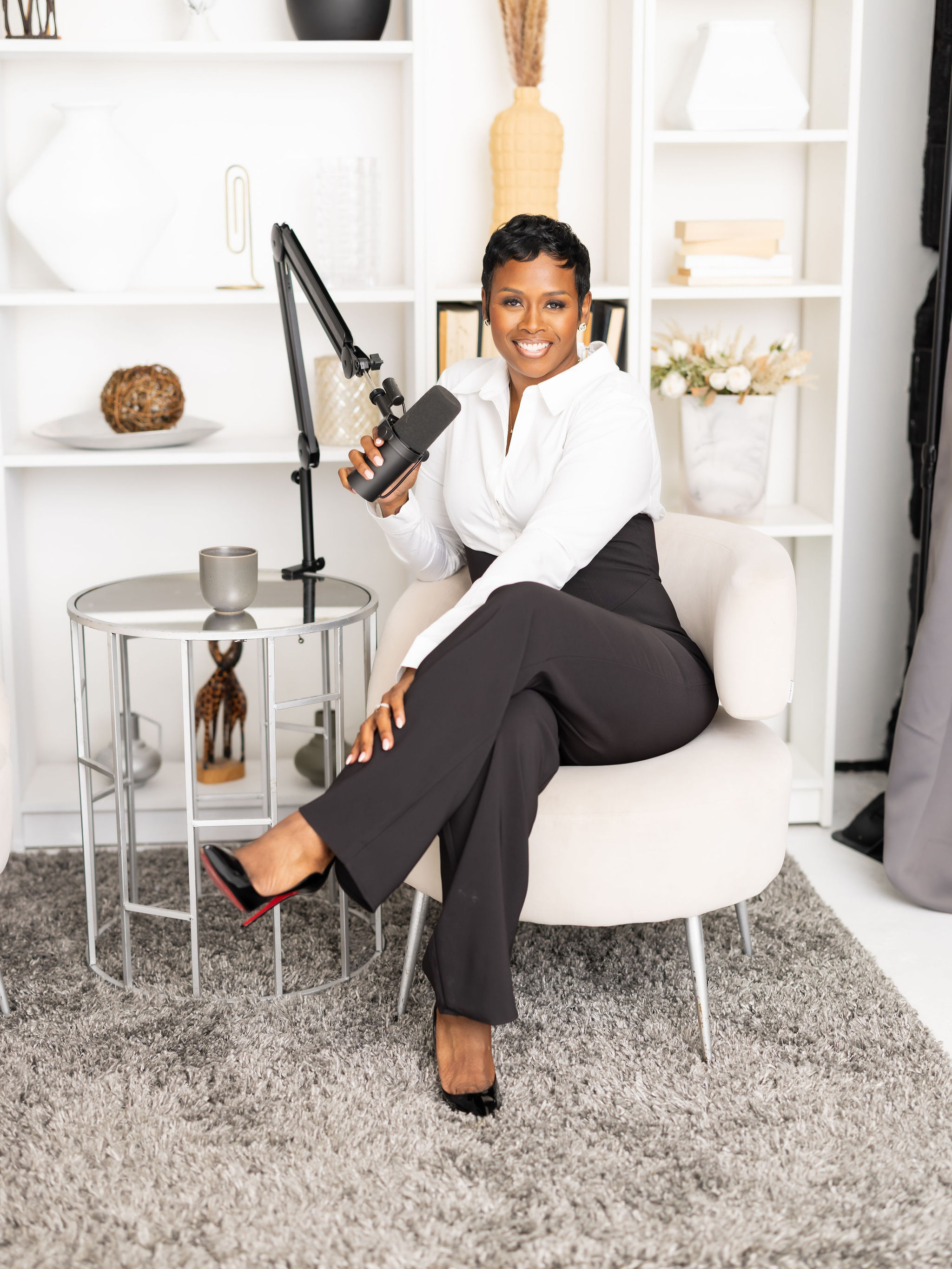 Autumn smiling at the camera while holding her podcast microphone