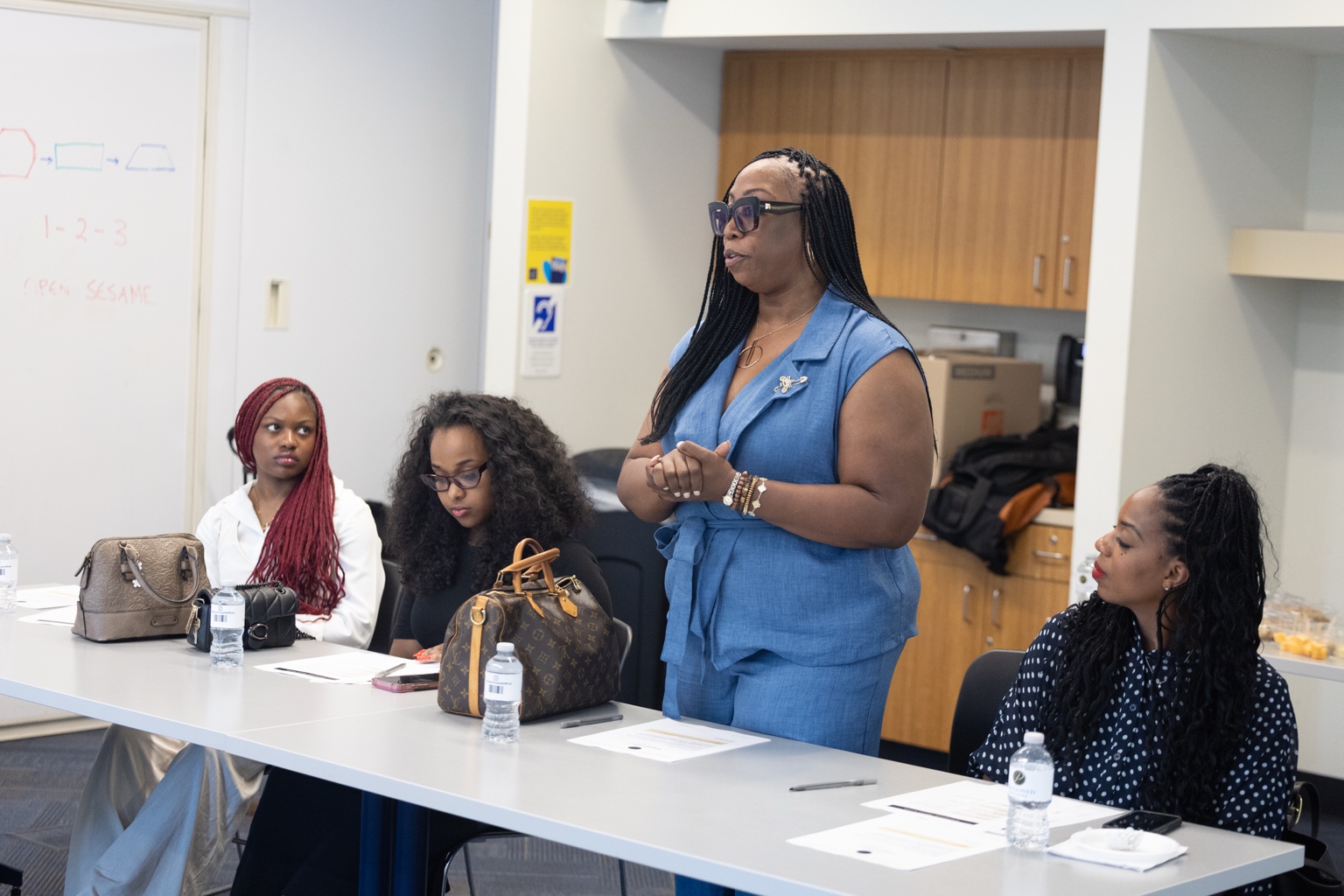 A woman speaking during an experience hosted by Autumn