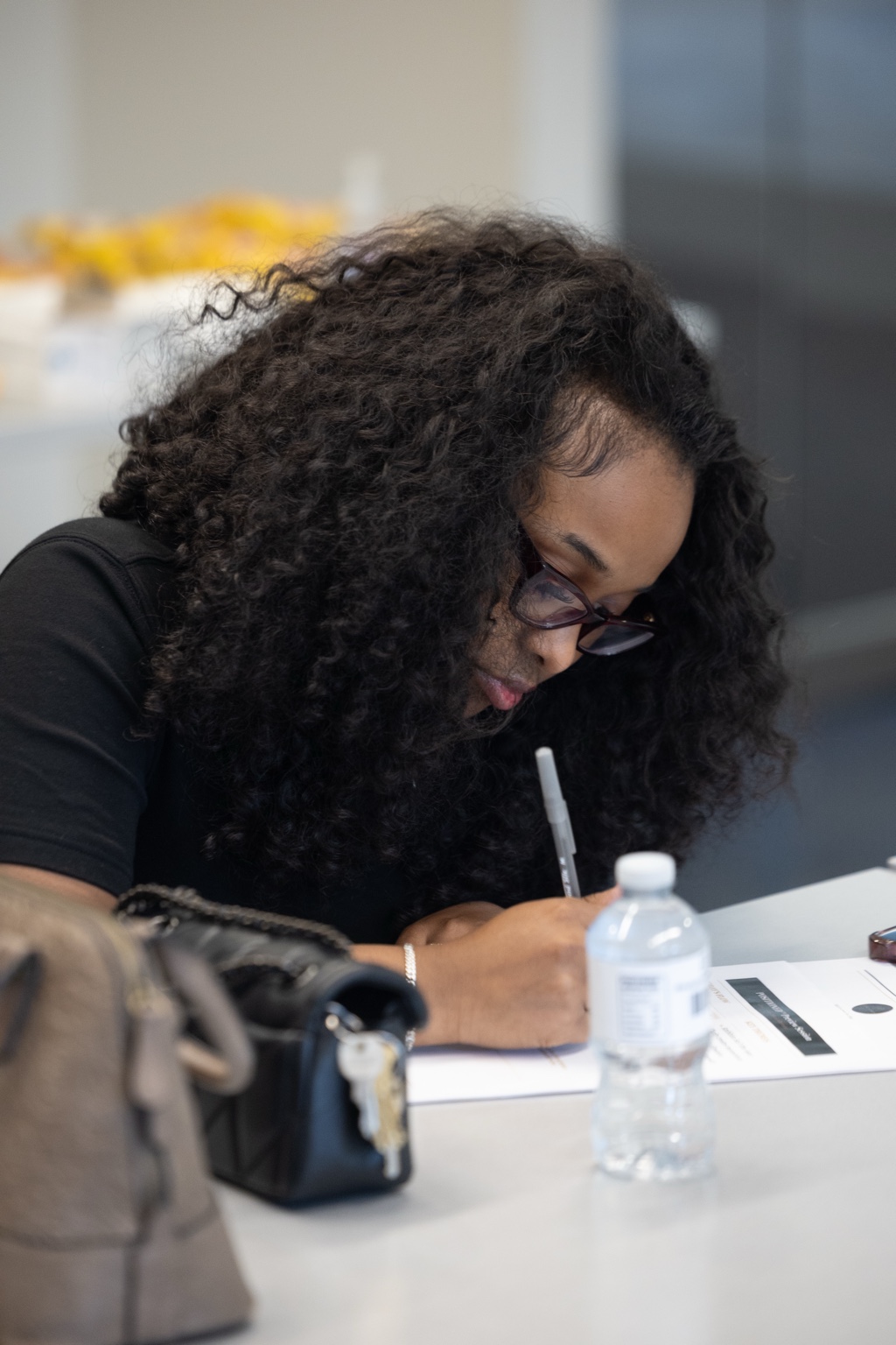 A woman writing as she reflects on a guided resource